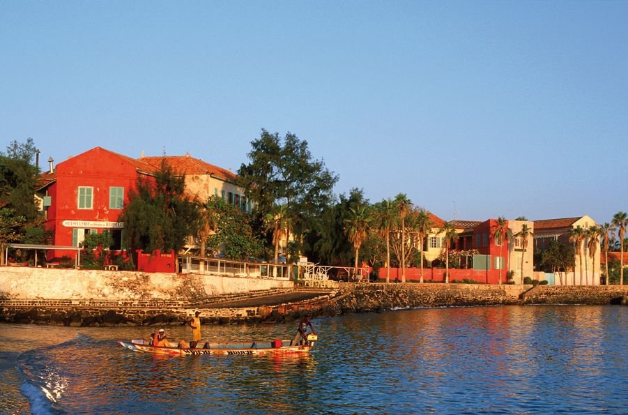 Gorée's waterfront, ochre and red houses on the bay